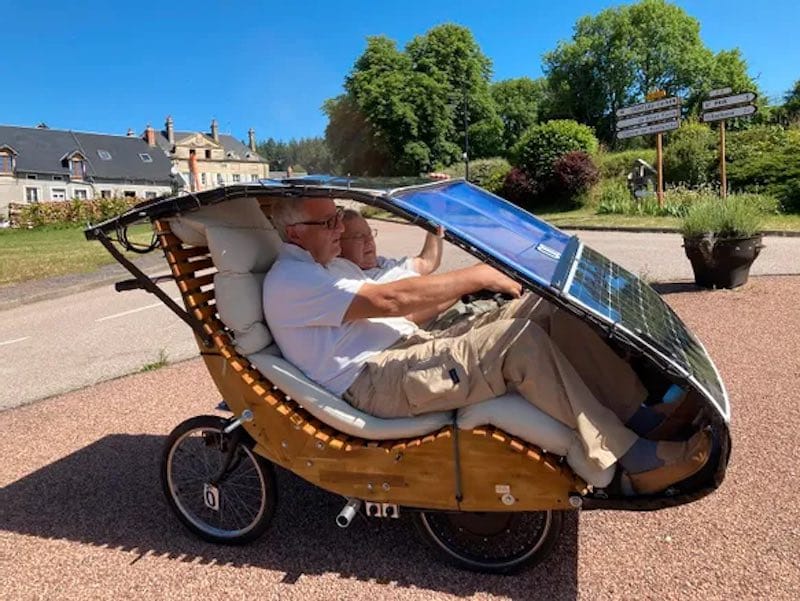 A retired engineer invents a two-seater solar car made up of two electric bicycles