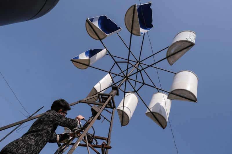 A young Lebanese builds a wind turbine with recycled materials to generate electricity for his house